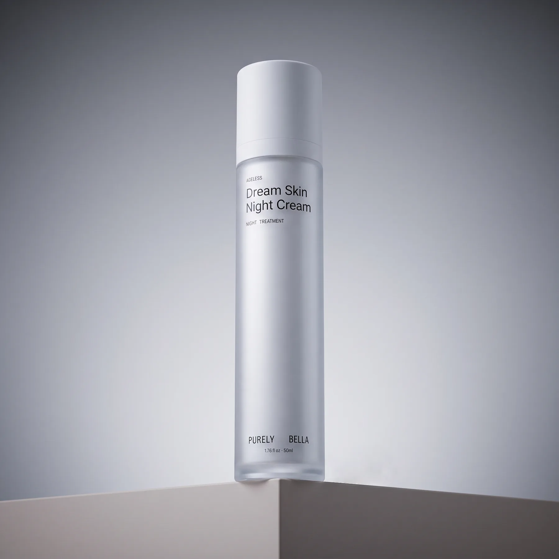 Frosted Purely Bella Dream Skin Night Cream bottle standing on the edge of a pale ledge