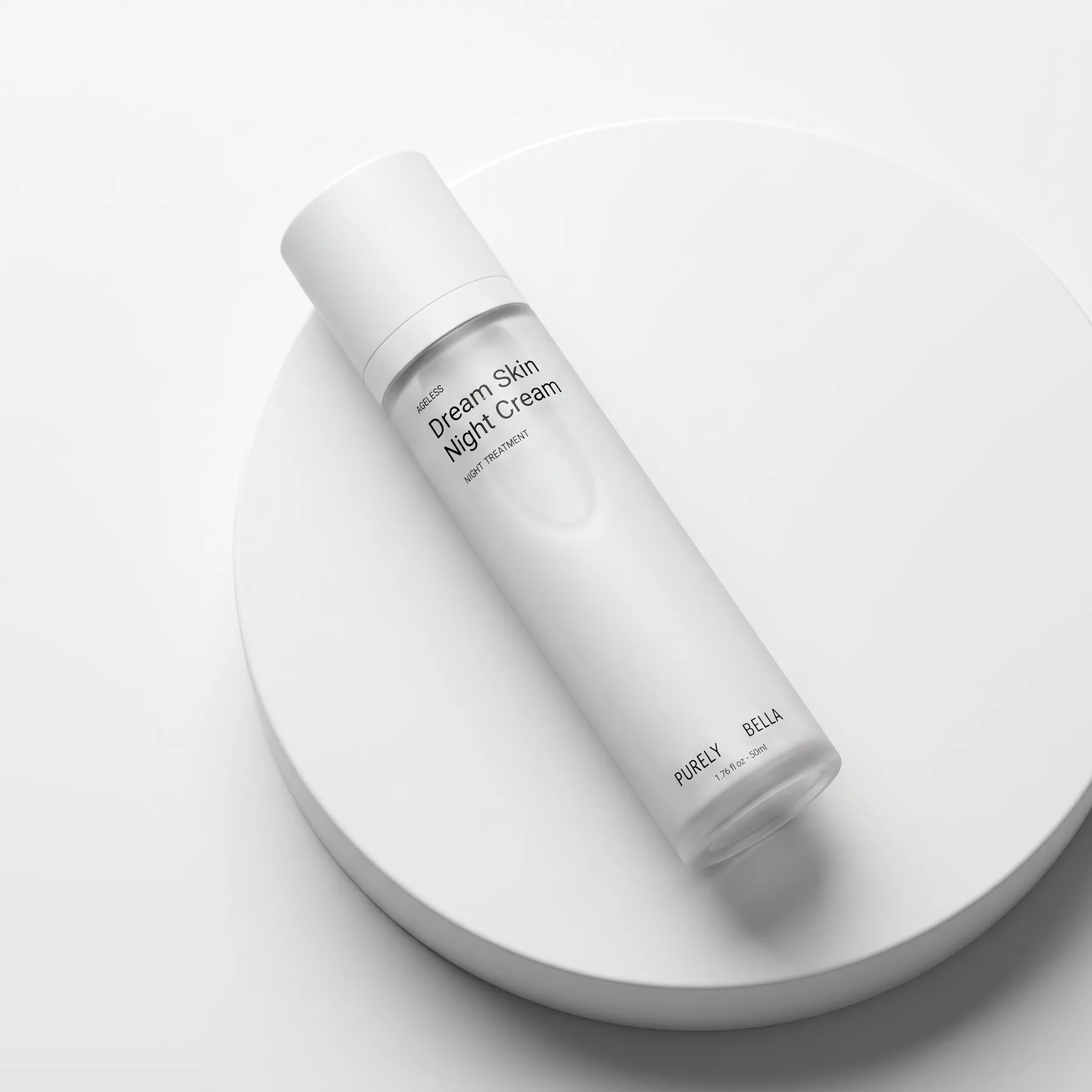 Purely Bella Dream Skin Night Cream lying on a round white pedestal, viewed from above